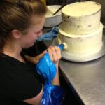 Piping a buttercream wedding cake
