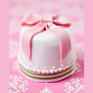 miniature white and pink ribbon wedding cake
